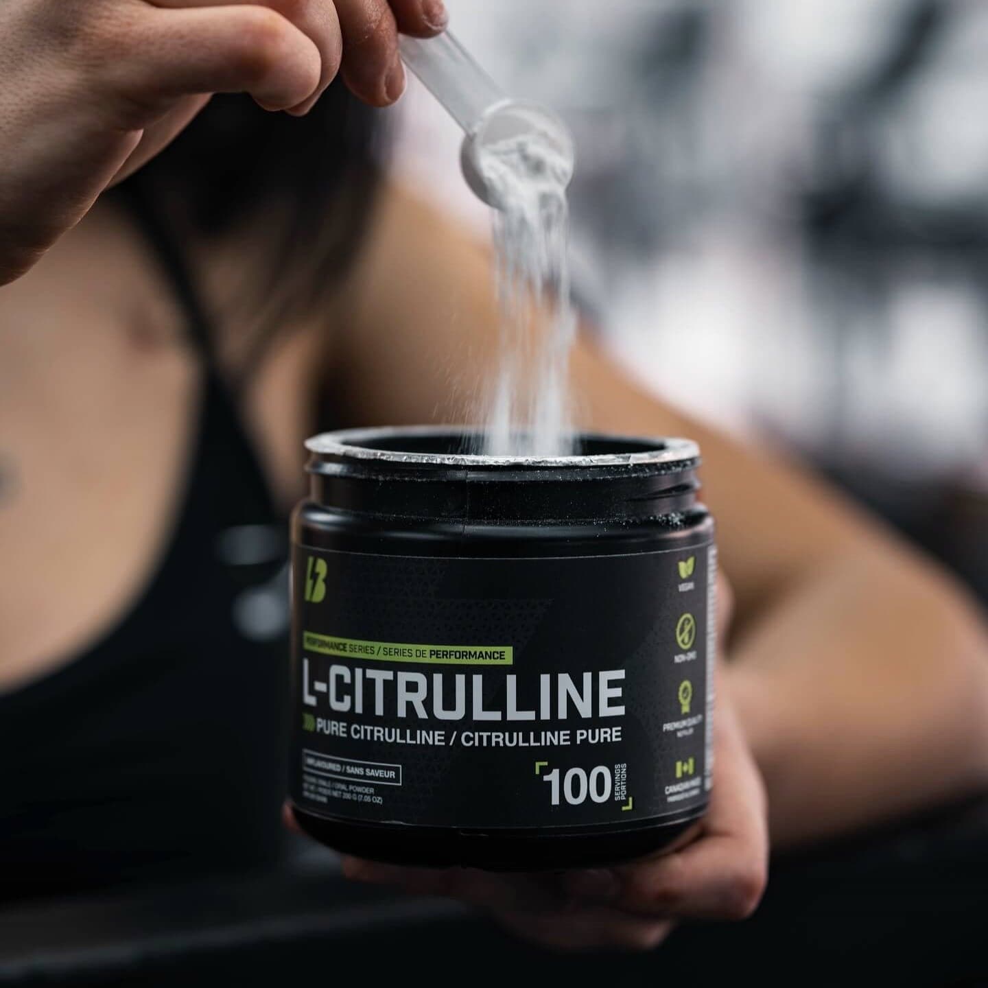 A scoop of L-Citrulline lifted out of the tub